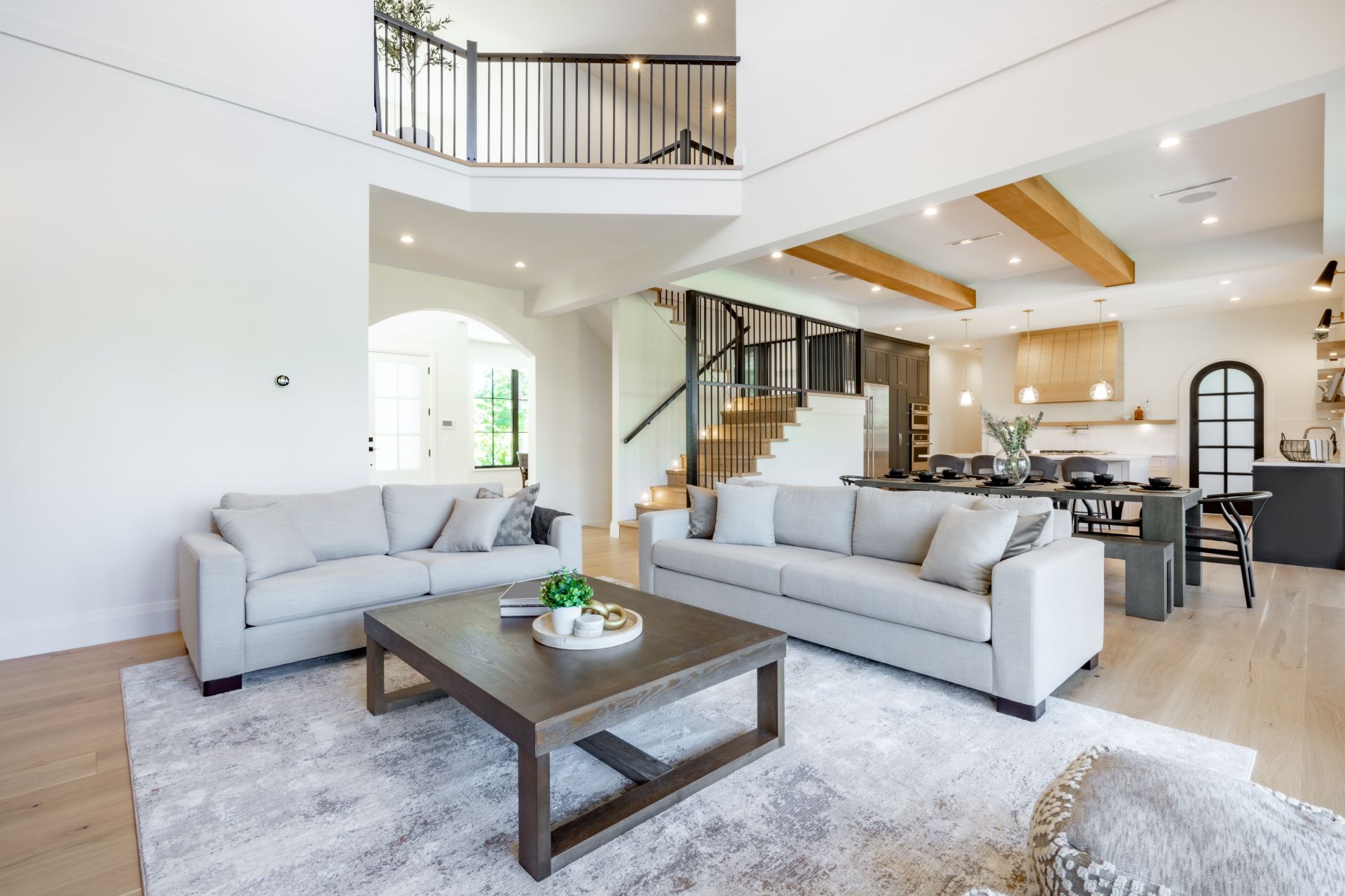 Elegant and spacious open concept interior rooms new construction with concrete floors designer decor wood beams on ceiling classic style