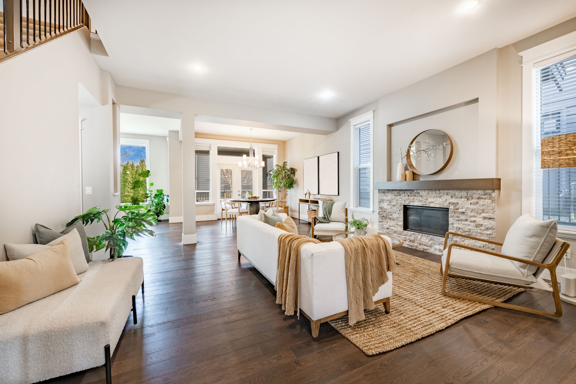 Simple living room interior with bohemian color tones moss green and beige hardwood floor staircase and a stone fireplace (1)