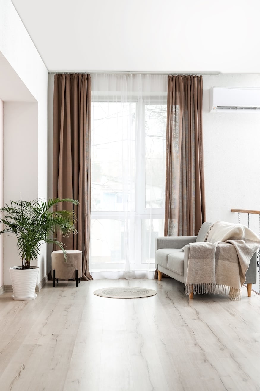 Interior of stylish living room with light curtains
