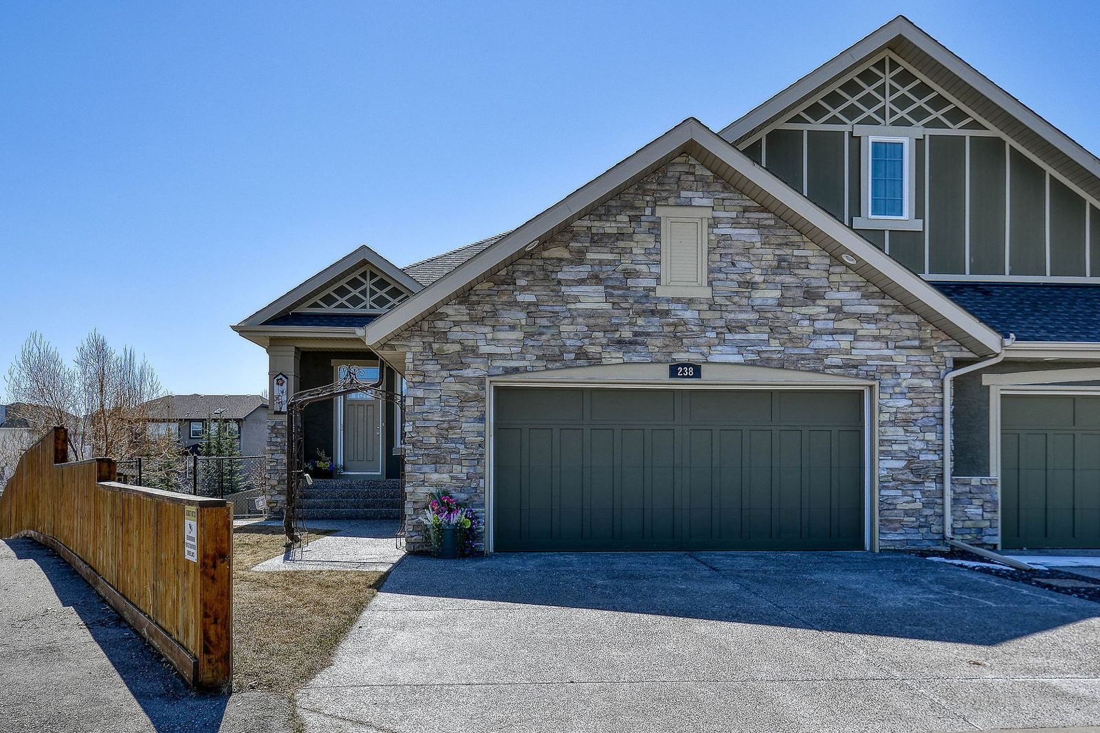 Bungalow-style home with a stone front and double garage in Cranston, southeast Calgary