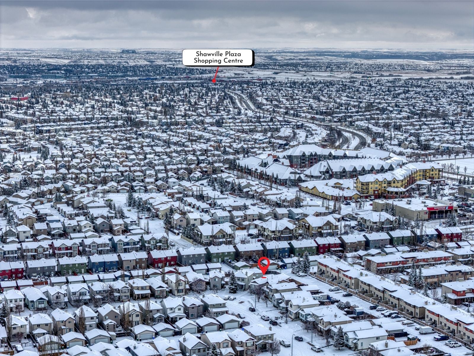 Aerial view of Evergreen in southwest Calgary in winter, with Shawville Plaza labelled in the distance