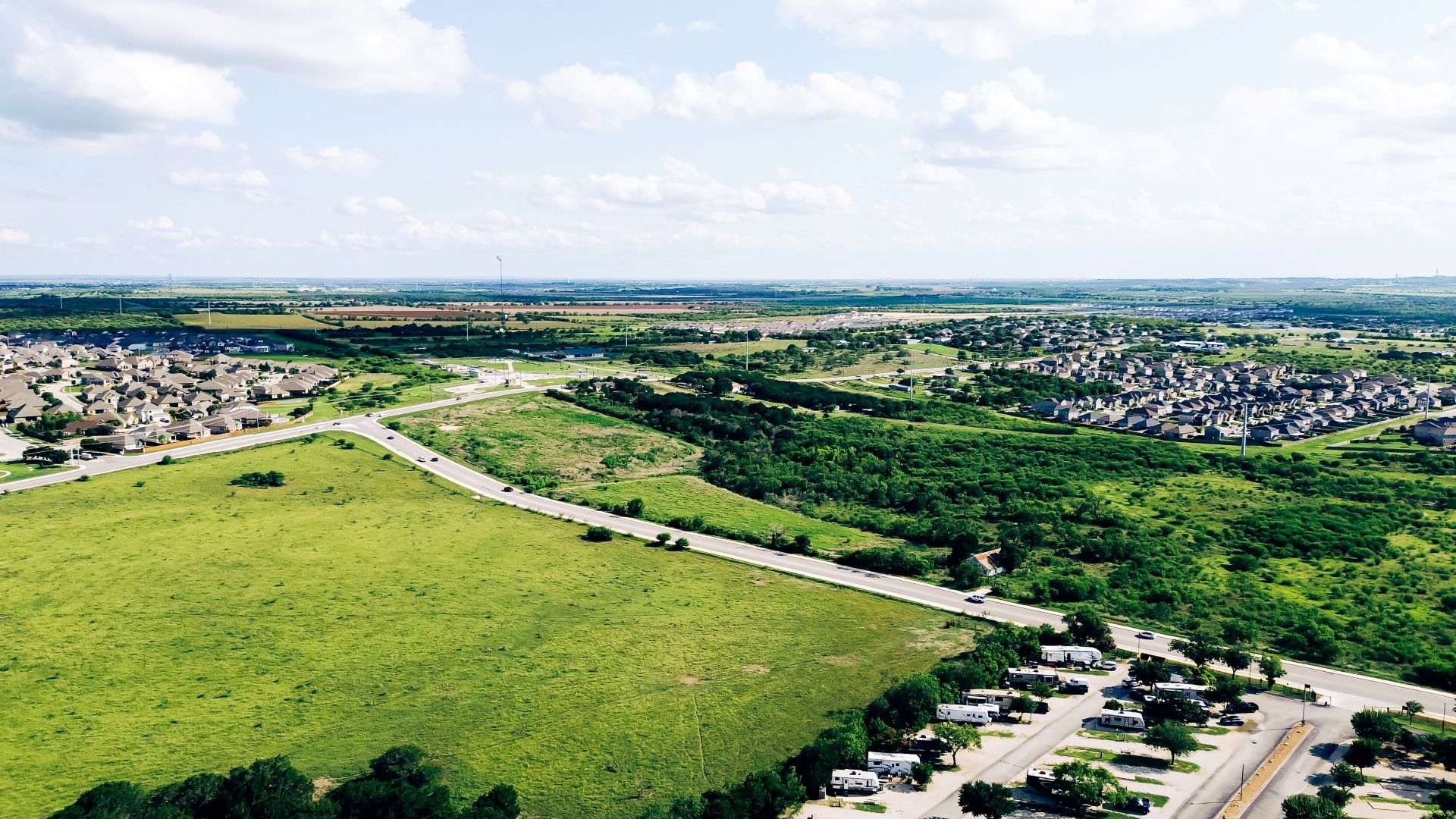 Large vacant land near new development residential neighborhood houses in New Braunfels, suburbs San Antonio, master planned community to grow along Rueckle Road and Morningside Drive, aerial. USA