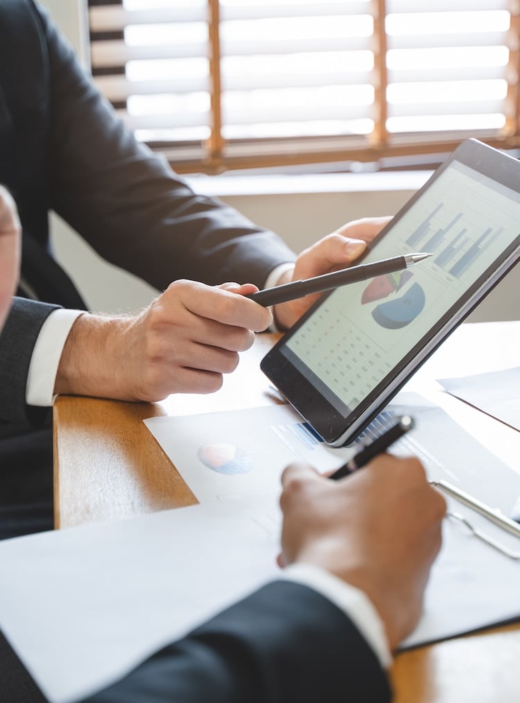 financial advisory services. Asian advisor showing plan of investment to clients in the consultancy office.