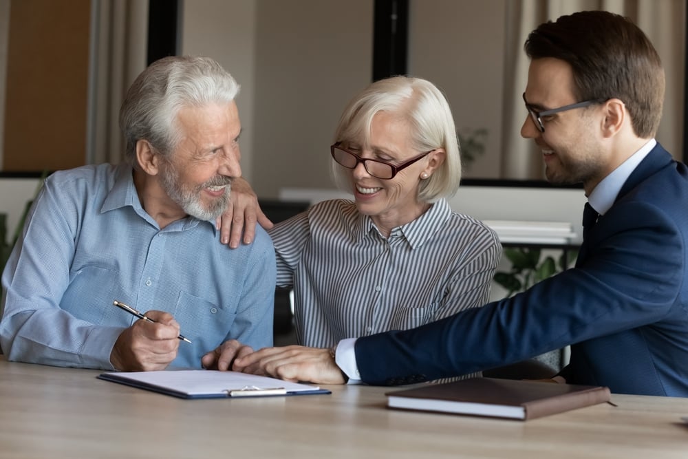 Excited,Mature,Couple,Signing,Contract,With,Businessman,Manager,Realtor,Broker,