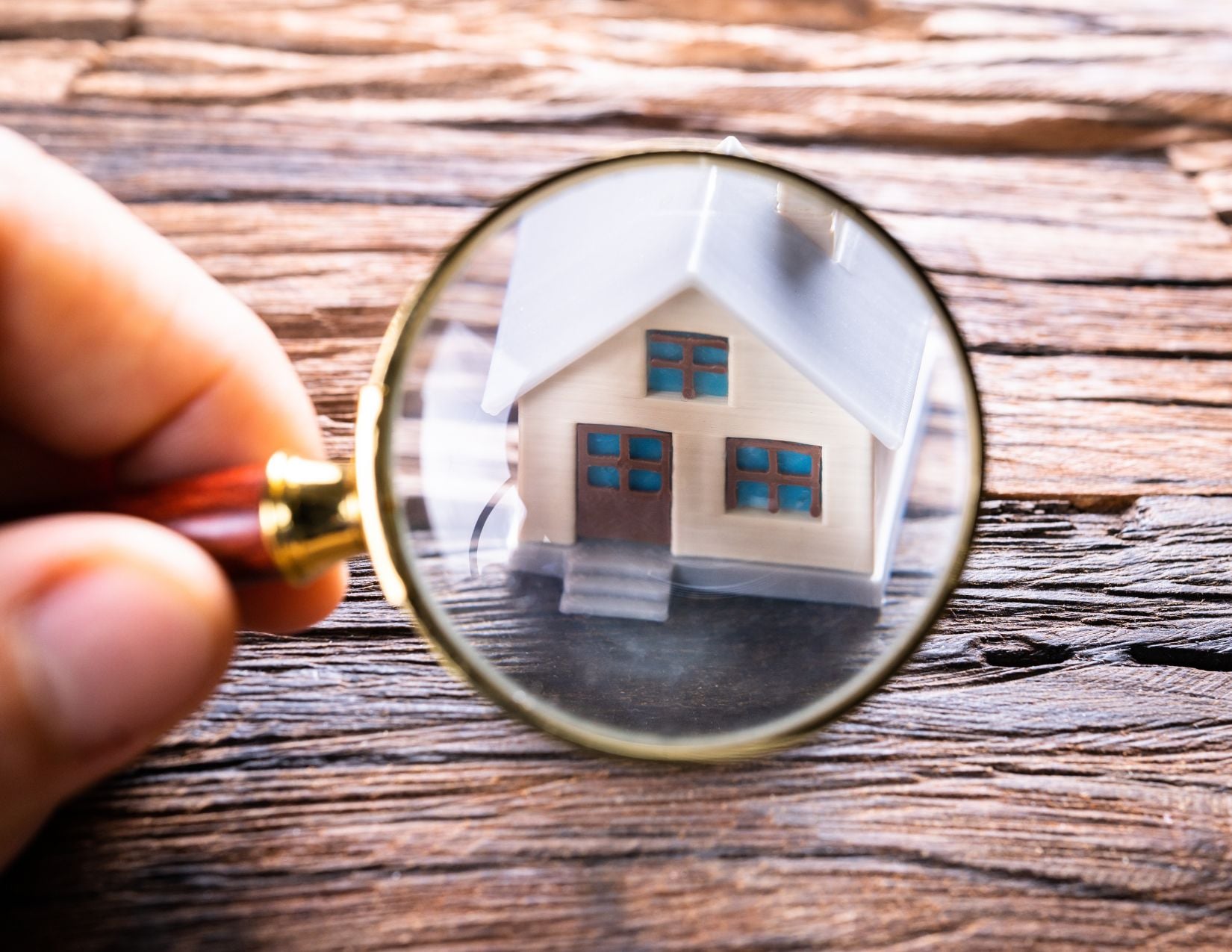 Picture of a home under a magnifying glass. Prepare for the home inspection. Amy Beyer Realtor in Grapevine, TX