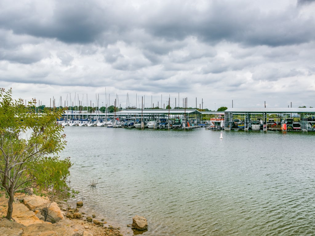 Lake Grapevine shoreline at golden hour with calm water and tree-lined coves