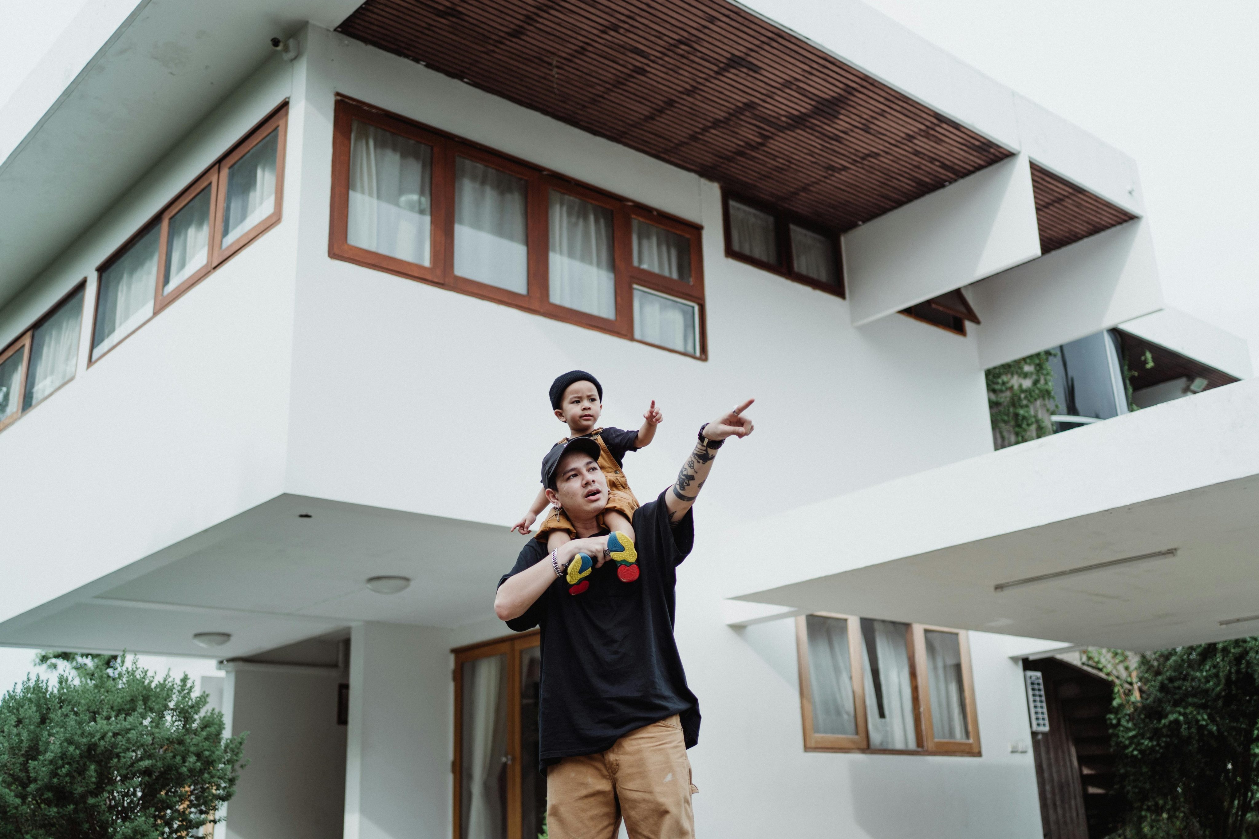man carrying son on shoulders