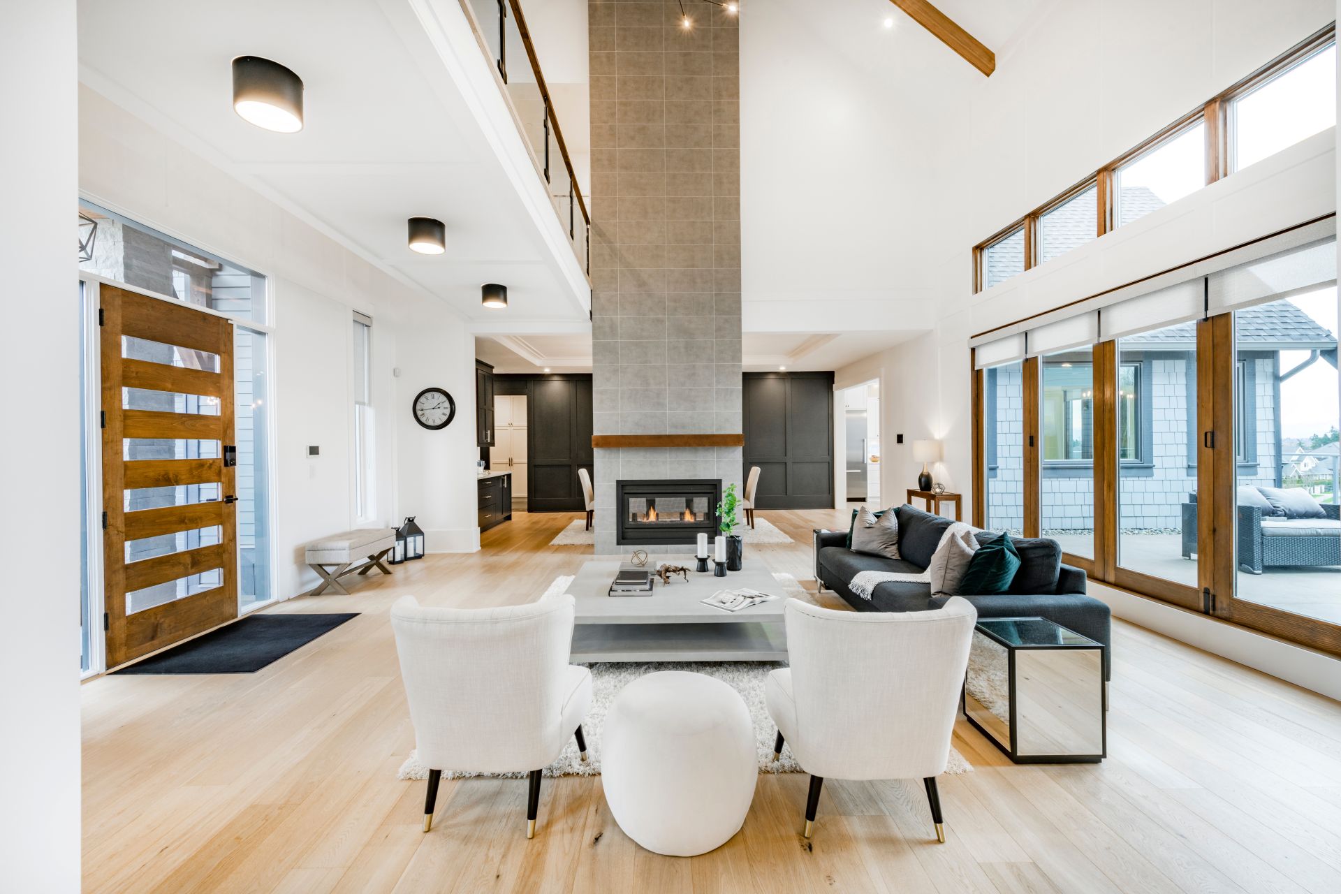 Large open concept great room with fireplace and wooden beams