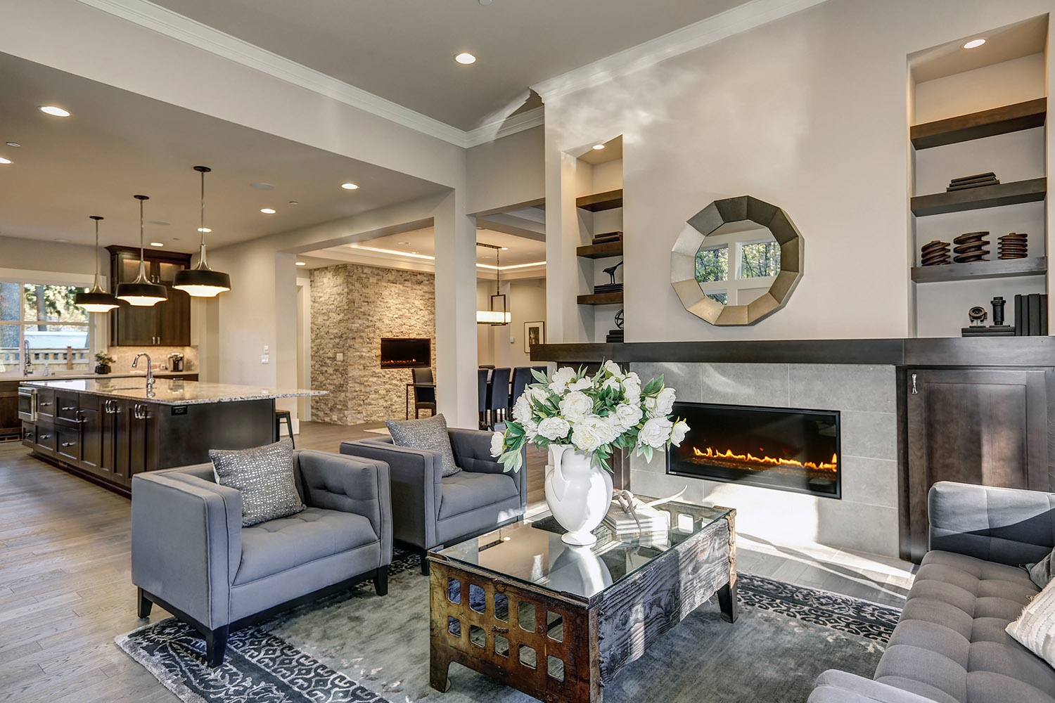 Chic,Living,Room,Filled,With,Built-in,Cabinets,Flanking,Round,Mirror