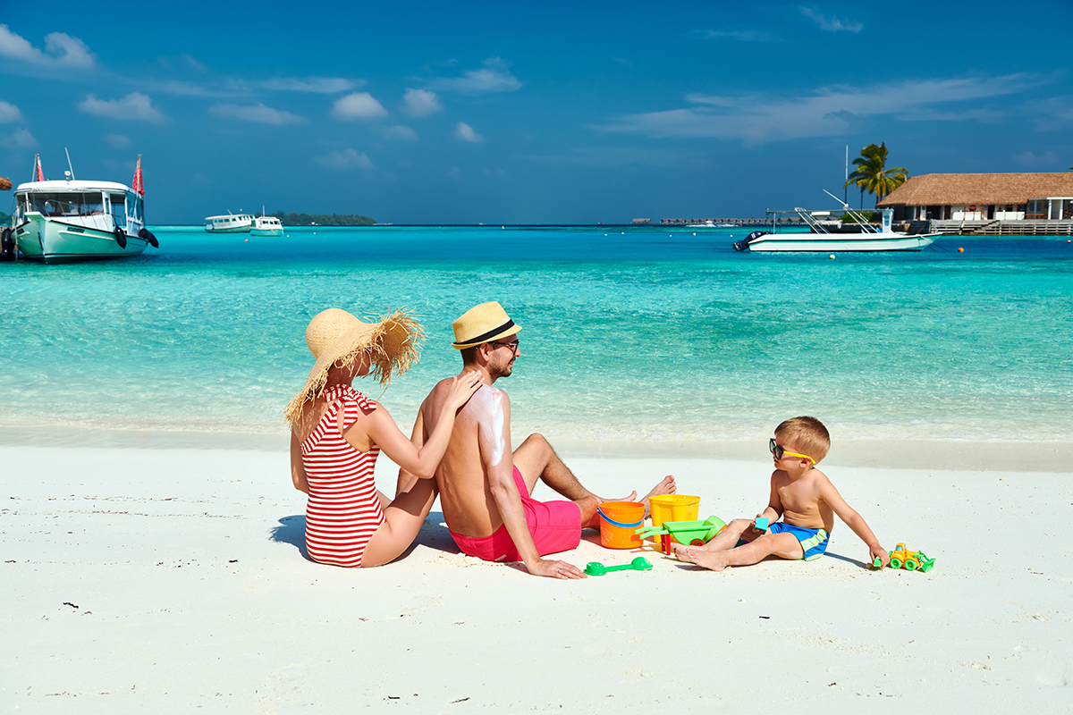 Family with three year old boy on beach