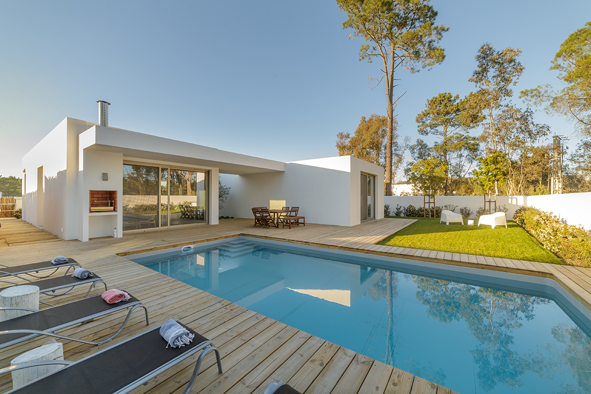 Modern house with garden swimming pool and wooden deck