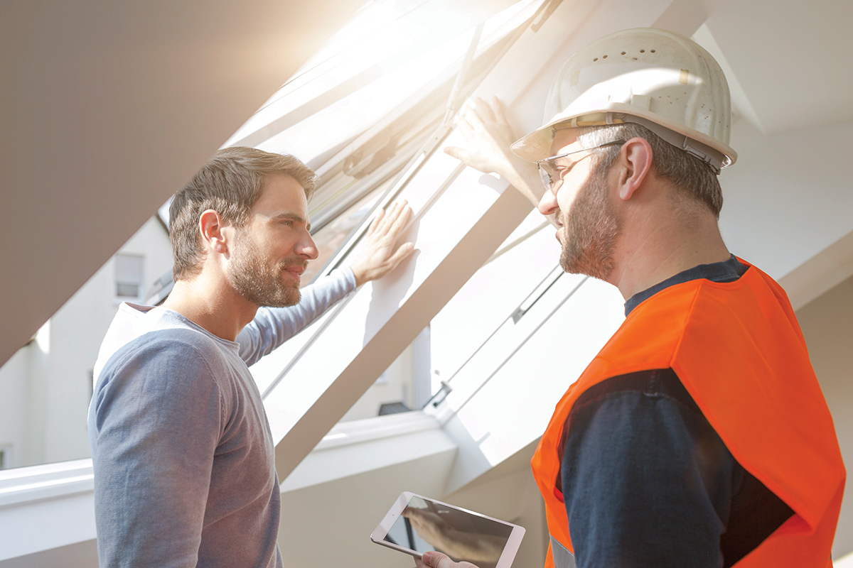 Construction worker discussing with building owner rebuilding of the apartment