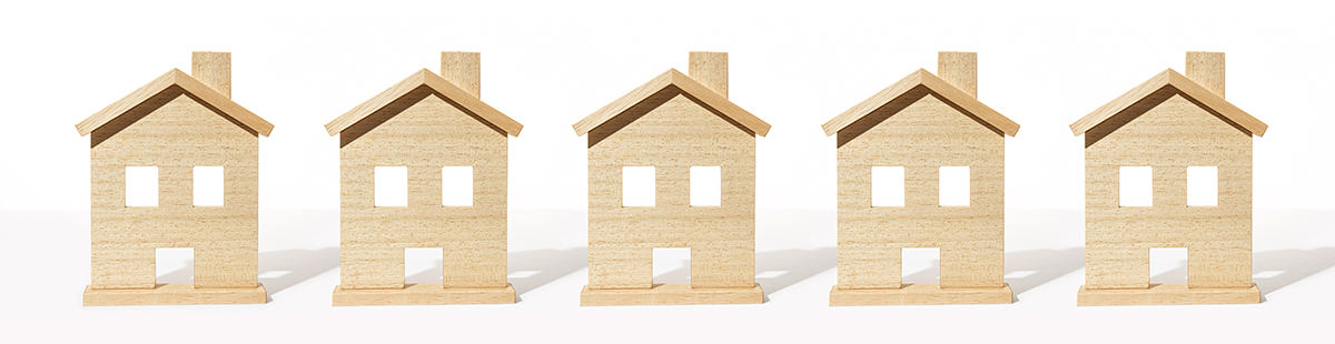 Real estate banner. Group of wooden house model on white backgro