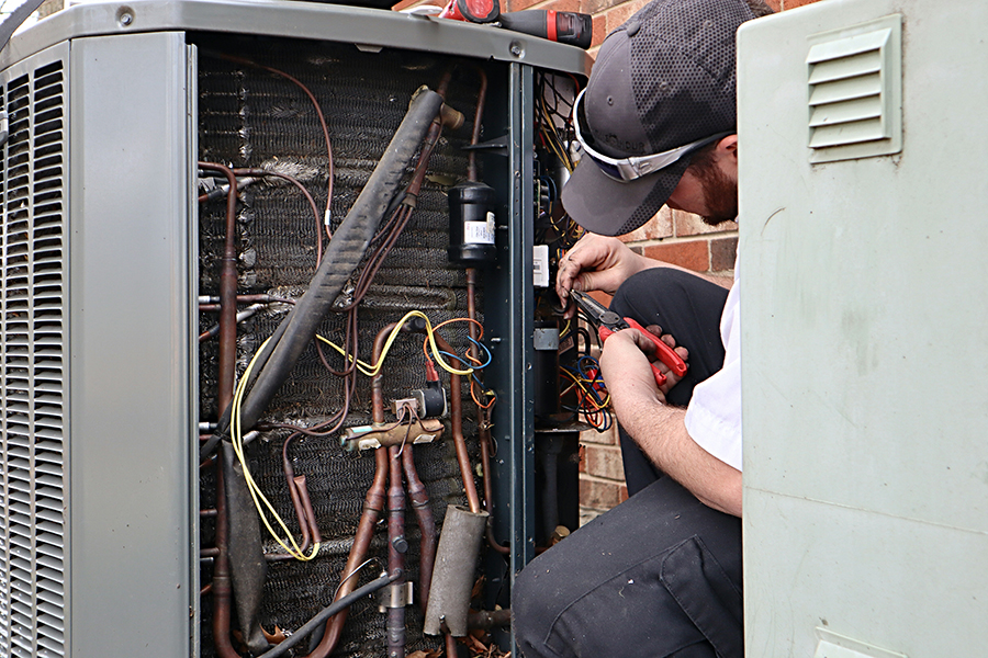 service-repair-being-done-on-a-heat-pump-hvac-syst-CUZ5KG7