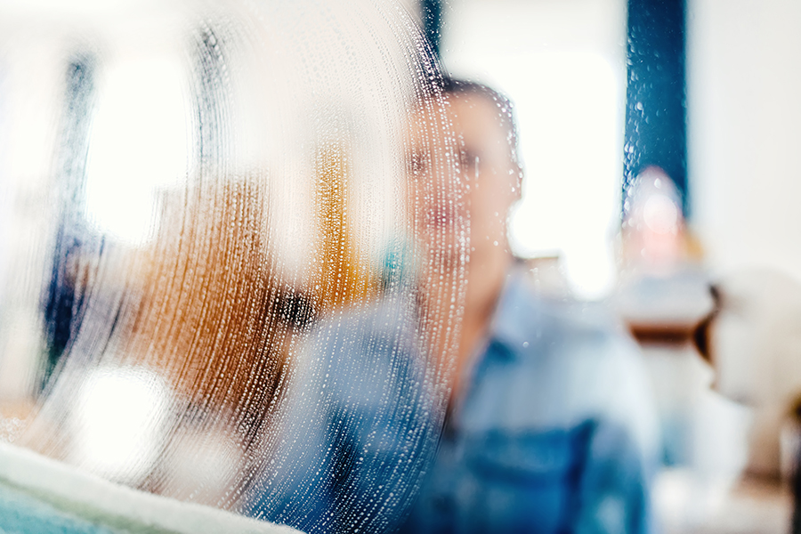 close up portrait, blurred out details of window cleaning. Soap