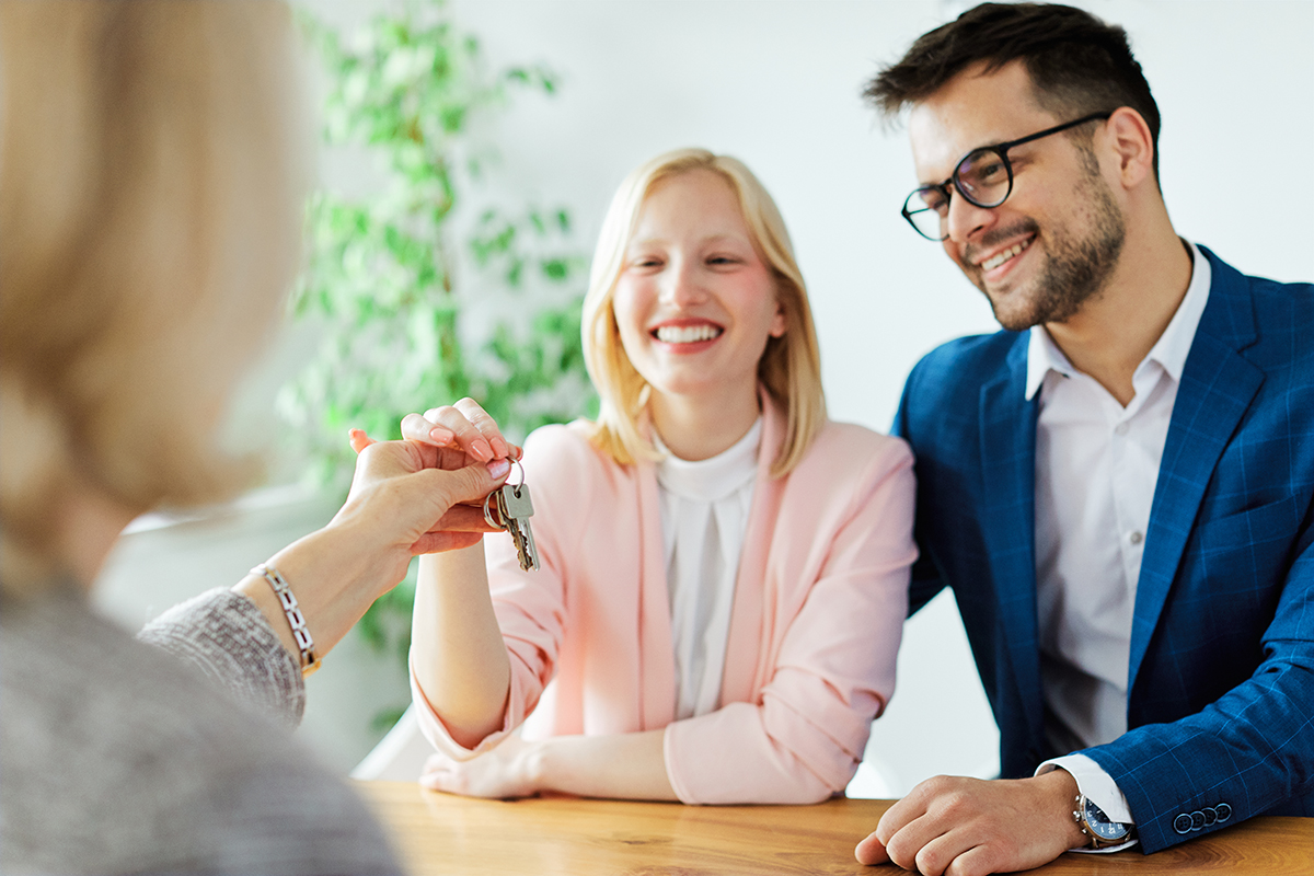 young couple new house keys buy real estate home agent agreement investment apartment