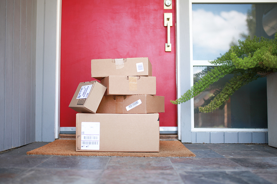 delivered-packages-stacked-on-the-porch-against-a-2023-11-27-05-20-23-utc