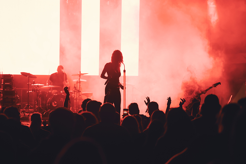 Crowd at concert and blurred stage lights.