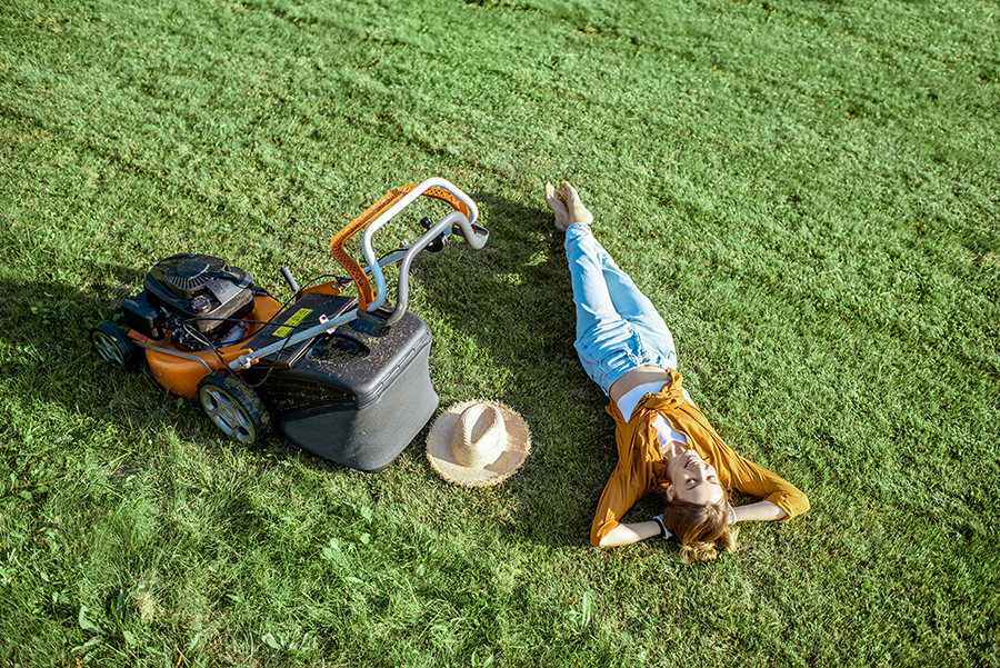 Woman on the grass with lawn mower