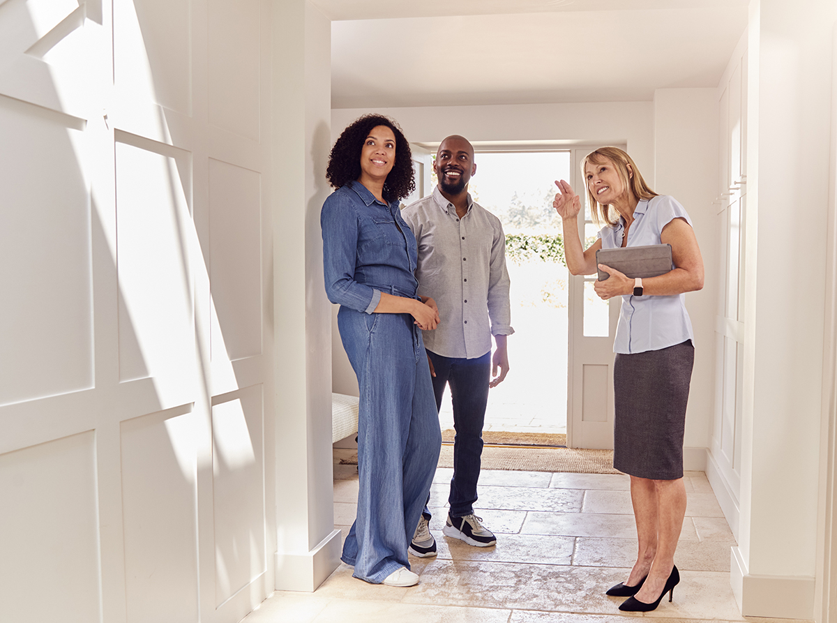Couple Viewing Potential New Home With Female Realtor