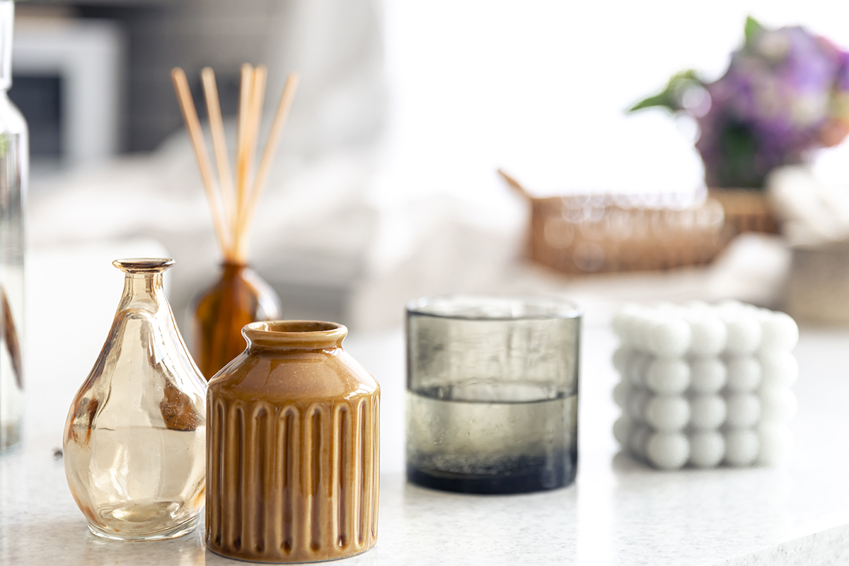 Vases and candles on a blurred background of a home interior.