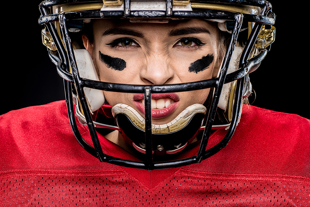 Close-up portrait of female american football player in sportswe