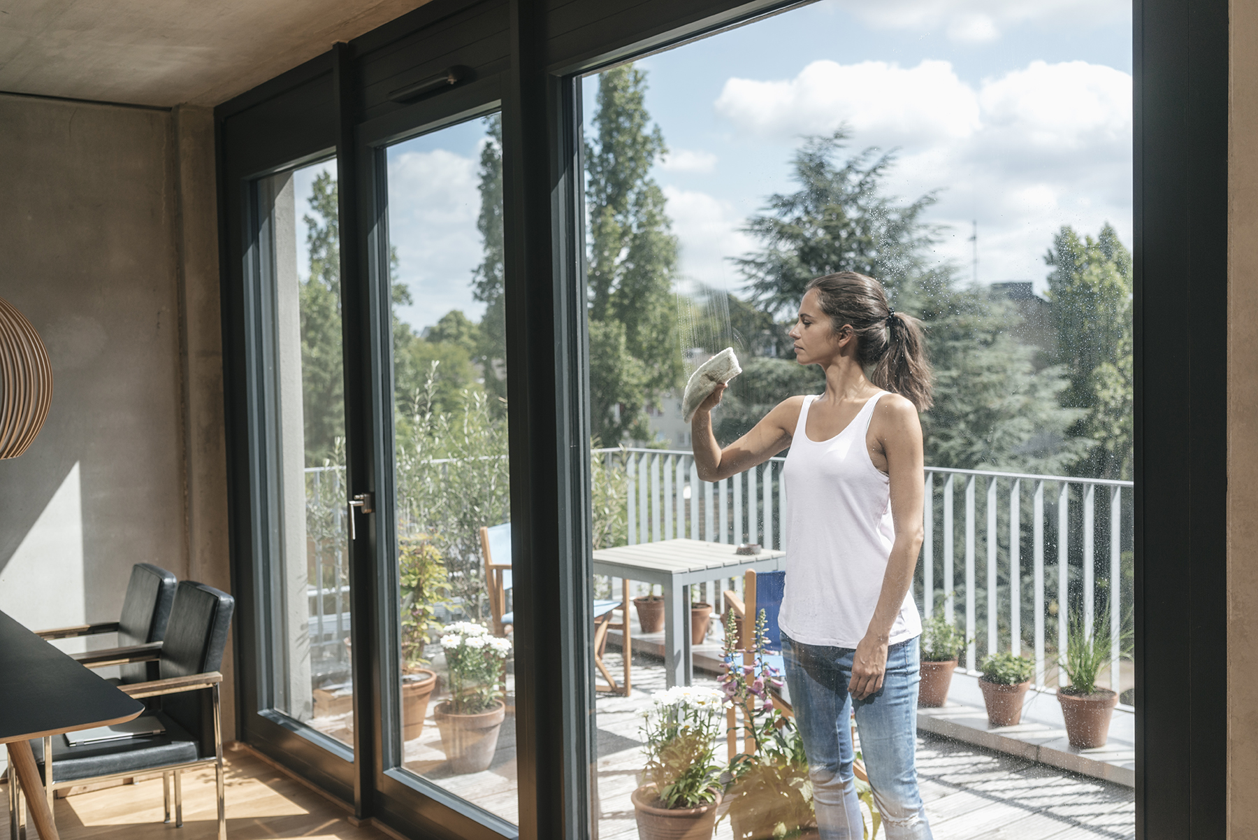 Woman cleaning balcony window