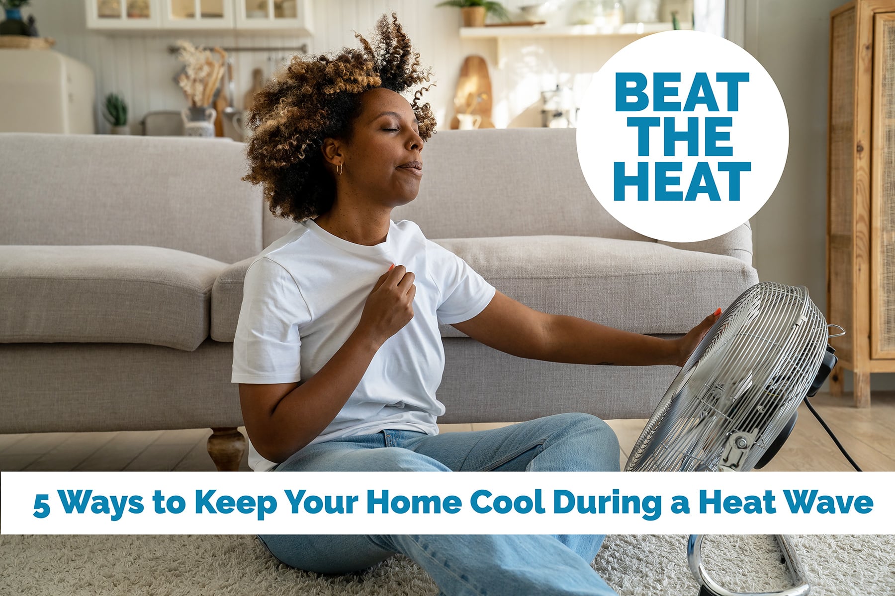 Young African American woman cooling down by ventilator at home, feeling unwell during heatwave