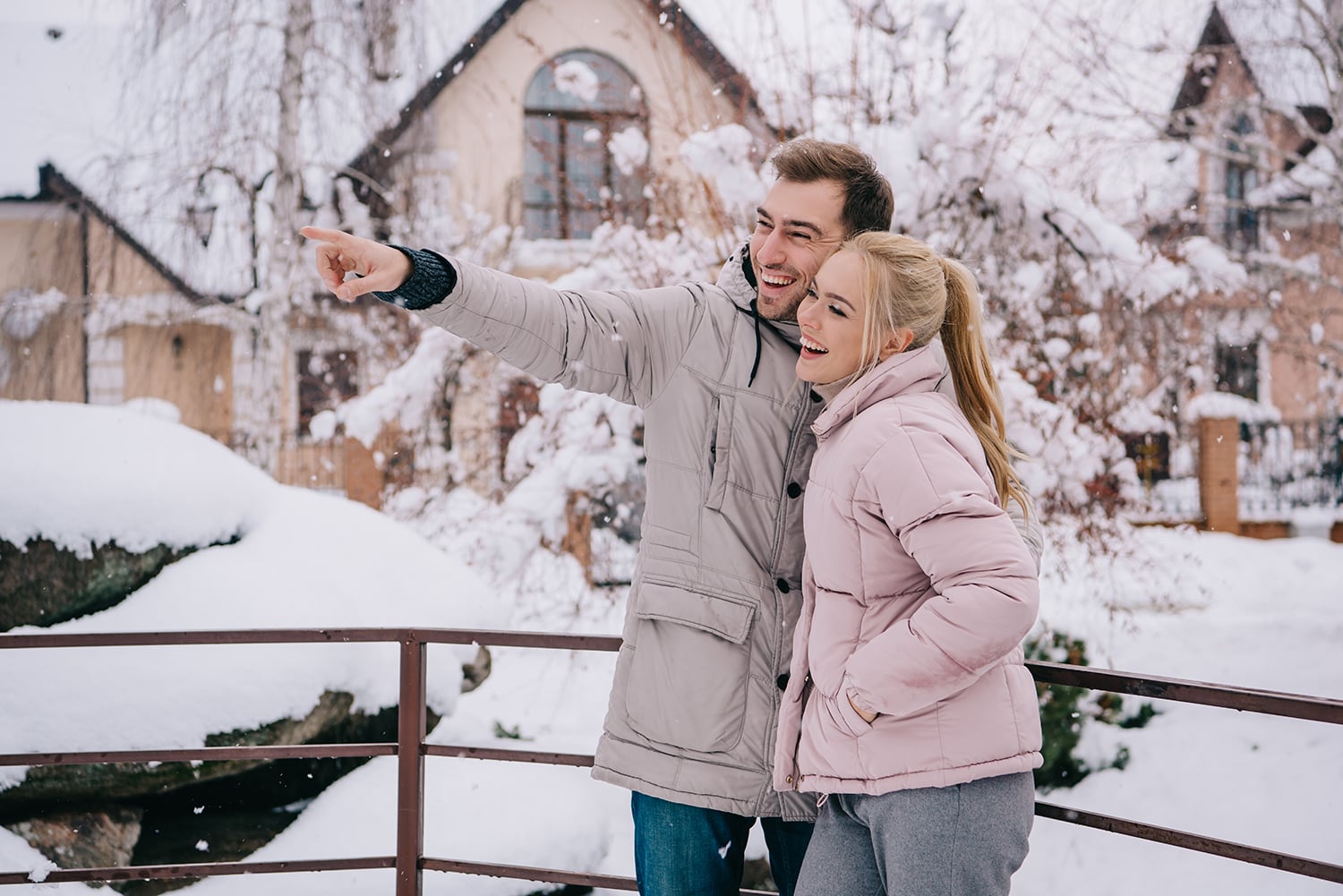 handsome man standing with blonde girlfriend and pointing with f