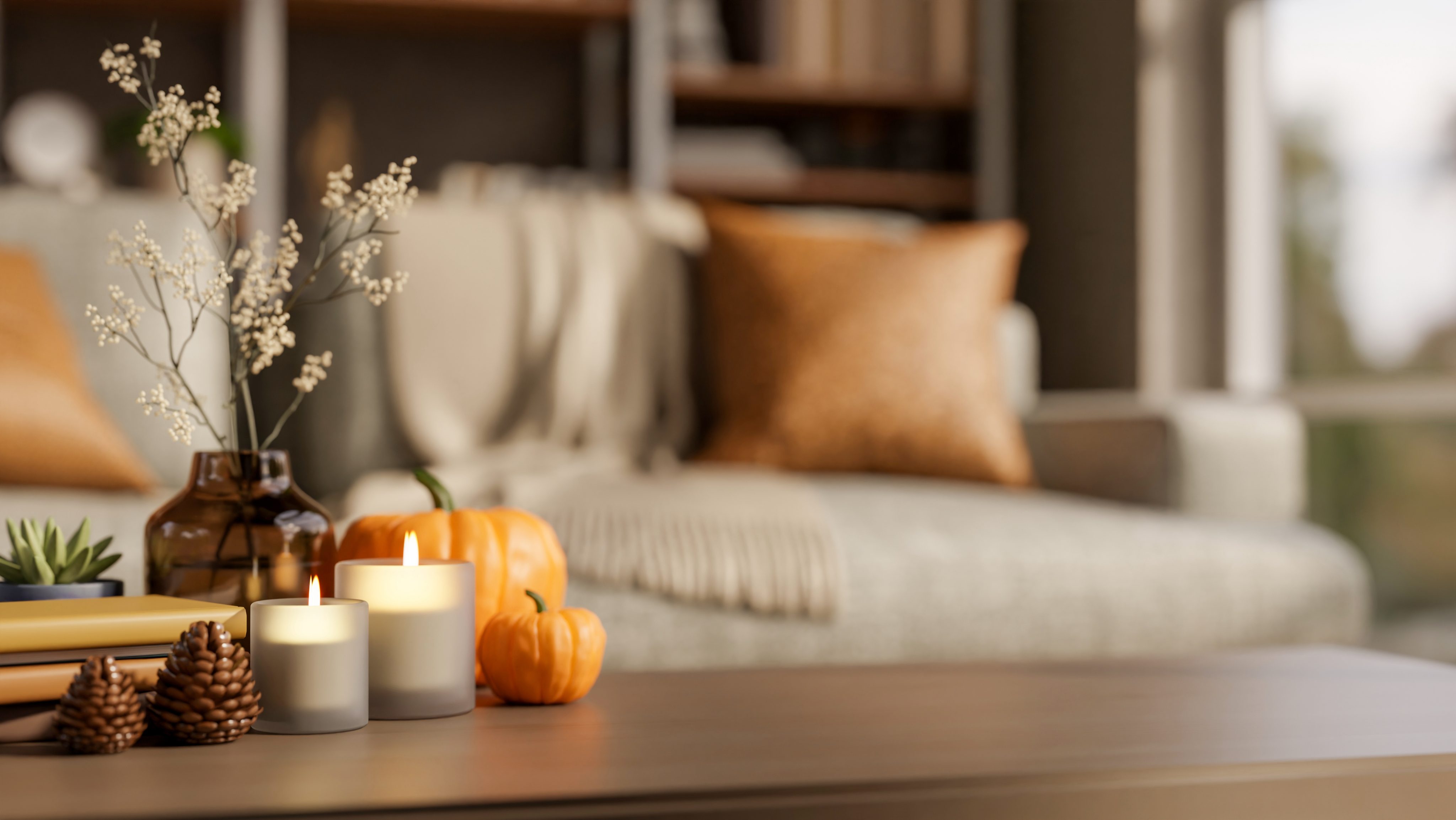Orange pumpkin halloween props with candles on wooden table aside sofa and window in a living room.