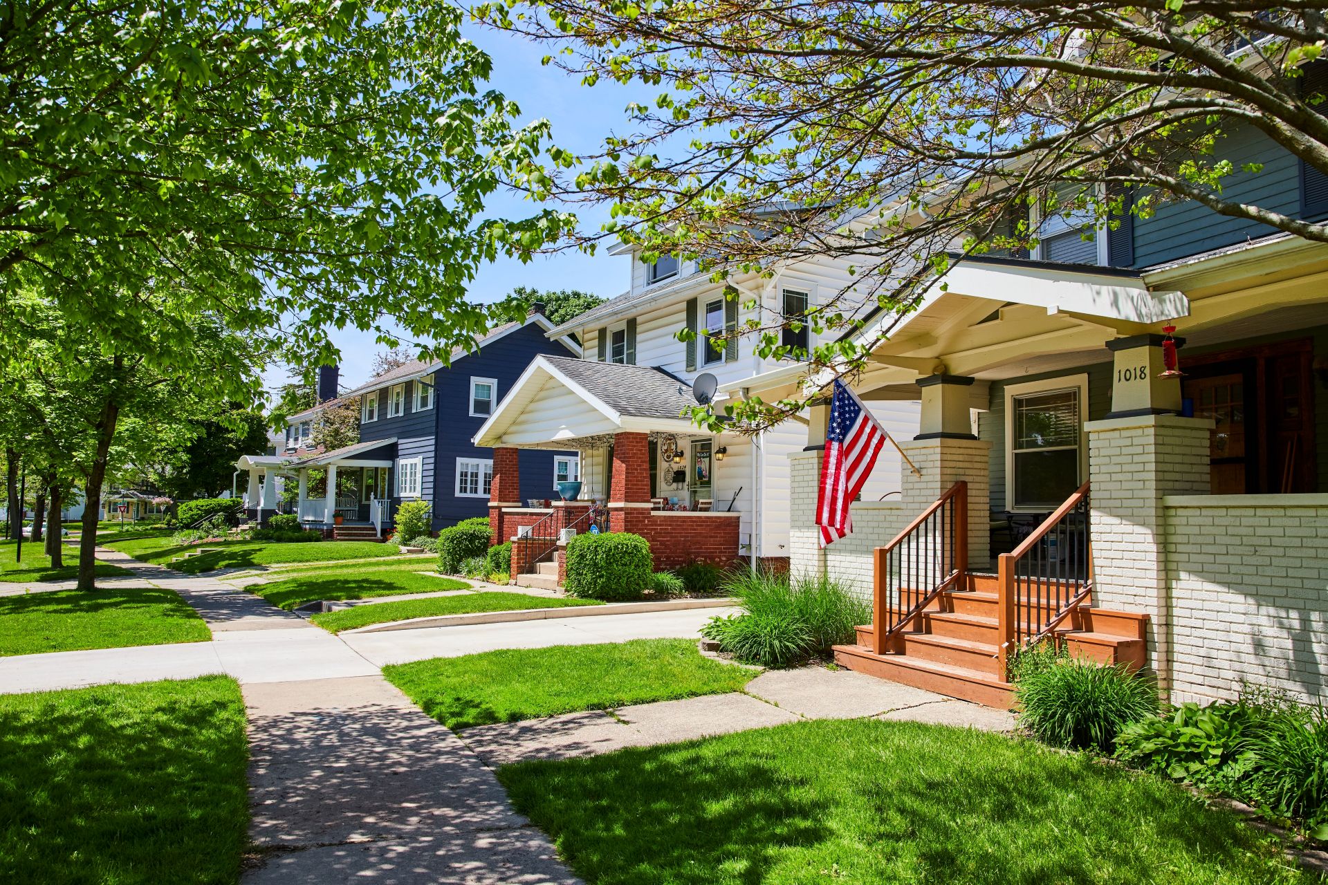 Charming American Townhouses with Flag, Sunny Suburban Street