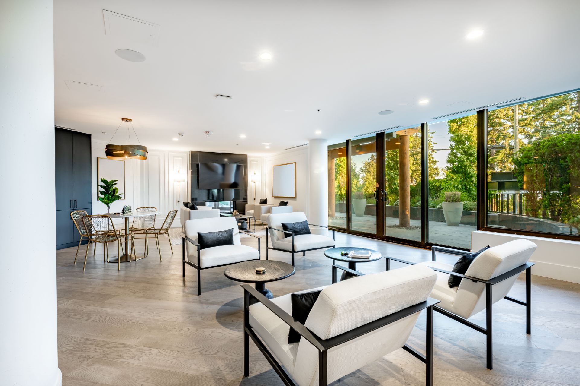 Interior of a condo building community space entry lobby concierge elevators party room kitchen theatre room public use space for apartment building with gym fireplace in the foyer