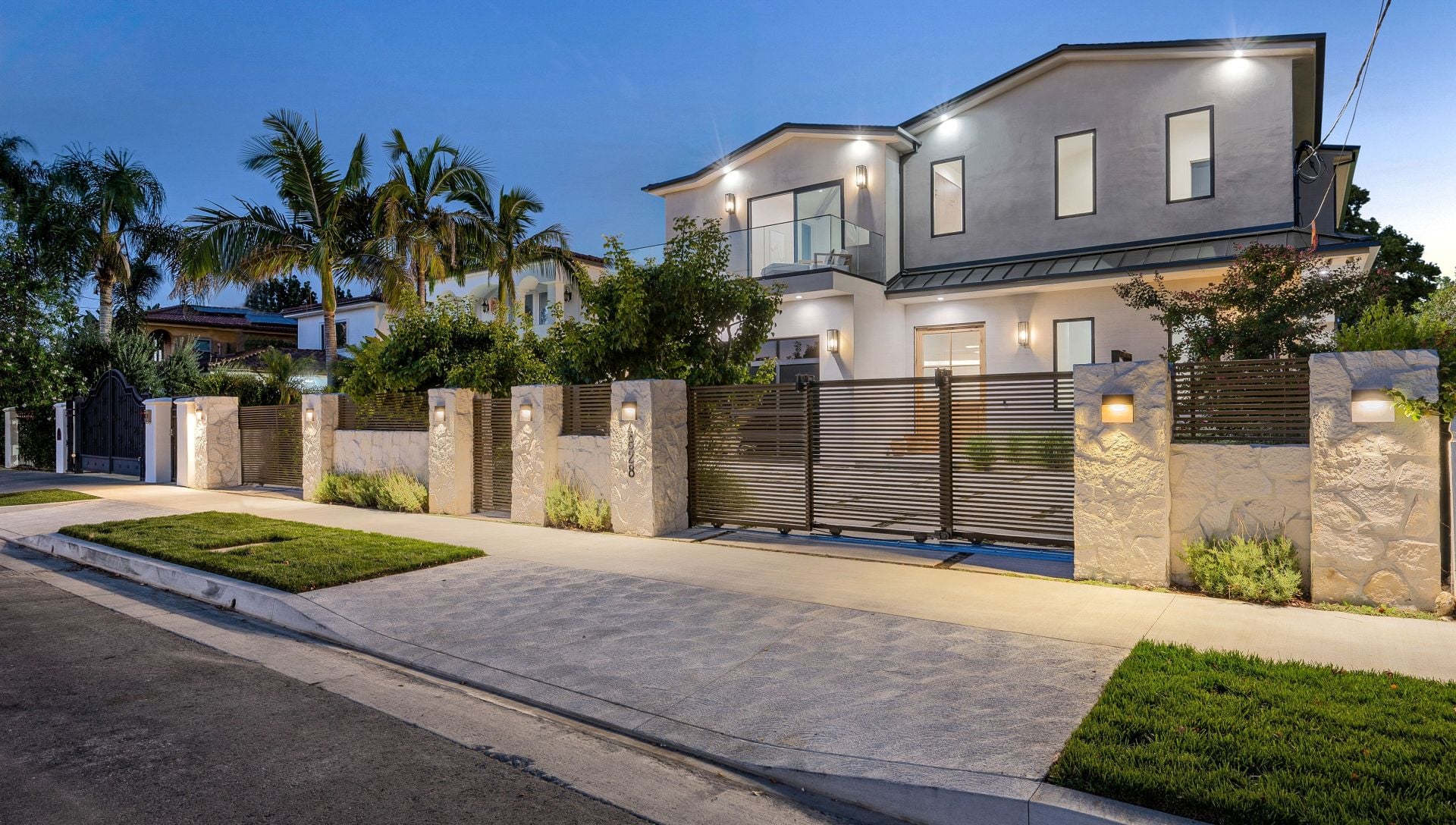 A house with a beautiful garden and metal gates. California, USA