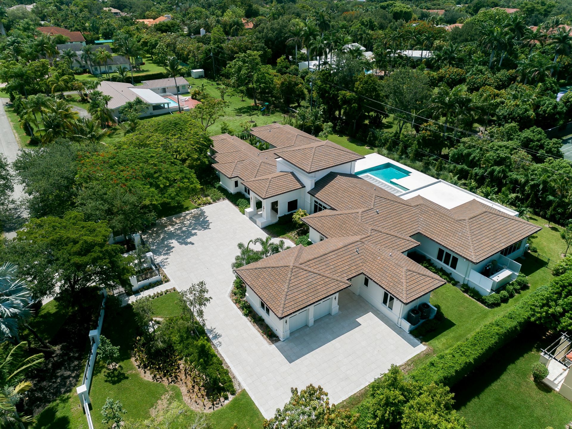 Aerial drone shot of the Pinecrest villa, in Miami-Dade, Florida, luxury mansions with large tropical vegetation around