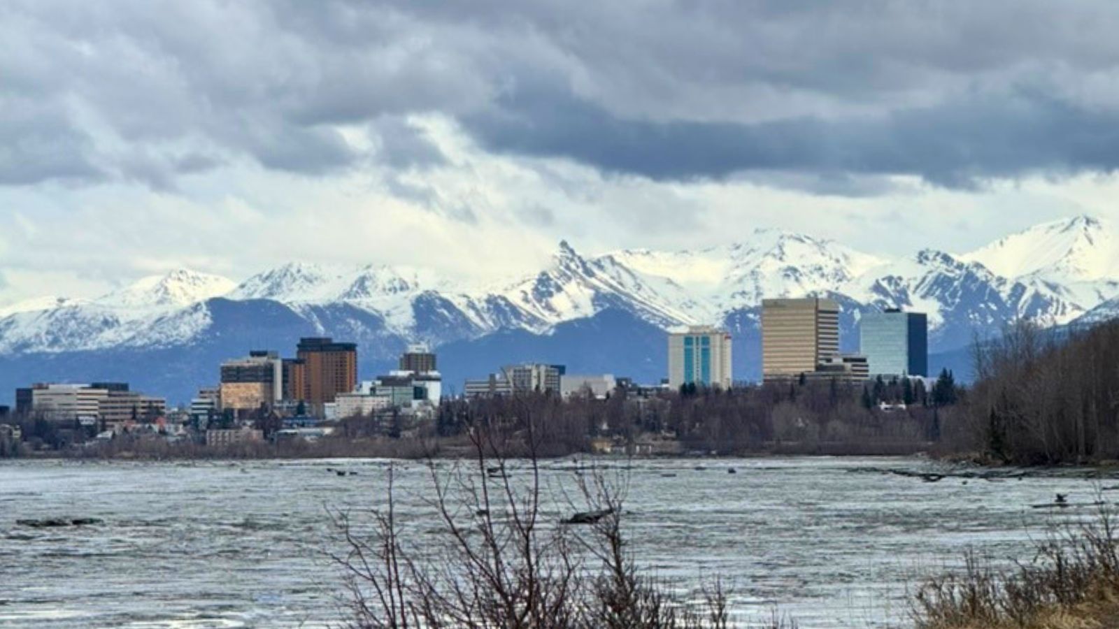 Downtown Anchorage skyline with snow-covered Chugach Mountains in the background