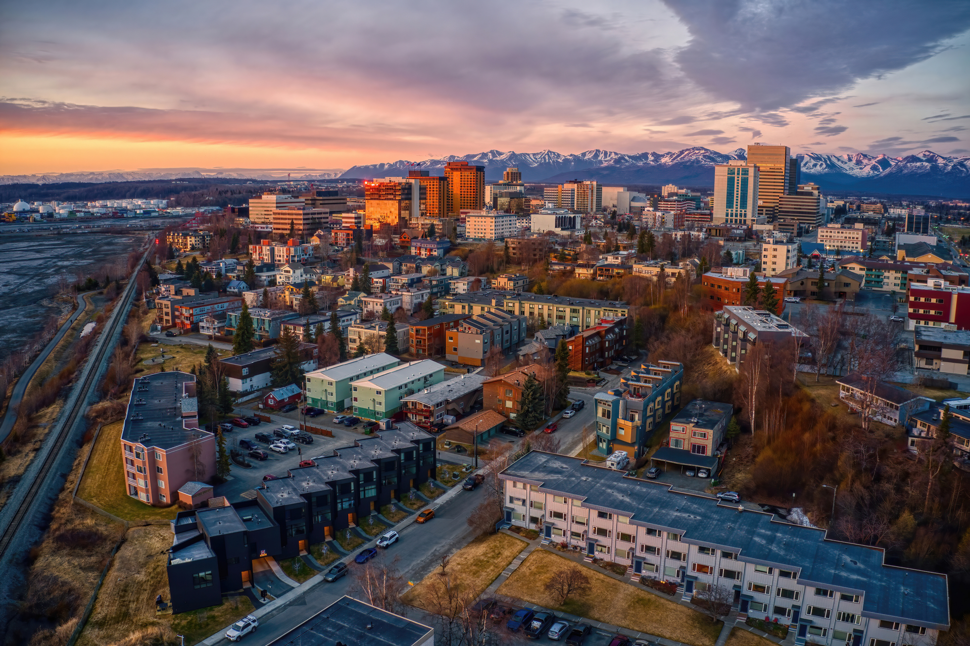 Aerial-View-of-a-Sunset-over-Downtown-Anchorage,-Alaska-in-Spring