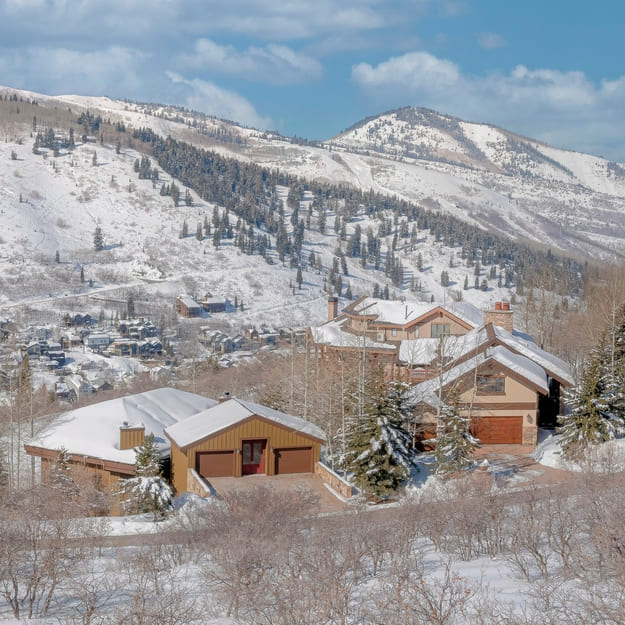 Square White puffy clouds Residential area near the snowy mountains at Park City, Utah