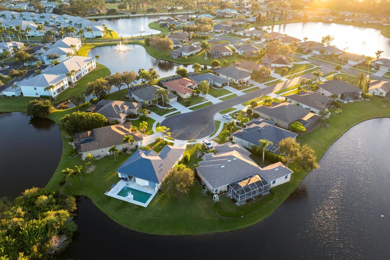 Low-density private homes at sunset. Rural street cul-de-sac dead end in residential suburbs with upscale suburban houses outside of Sarasota, Florida.