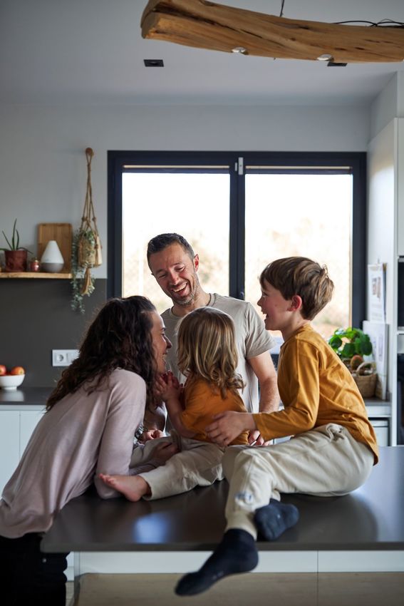 Happy young family loving and caring, being playful with their children