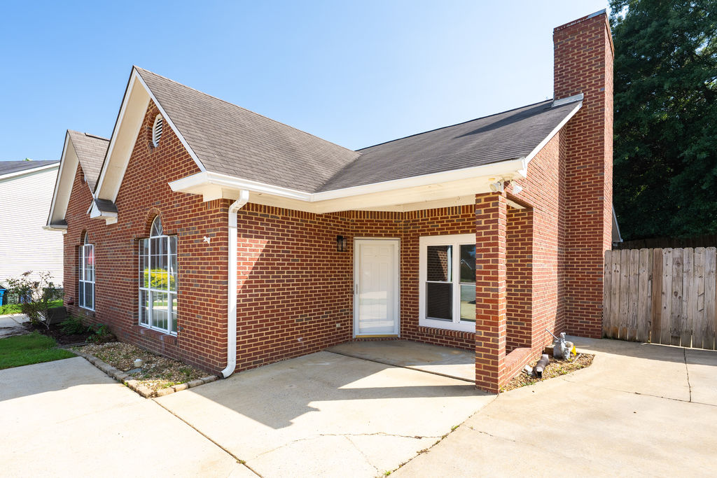 Covered entry and large concrete parking pad at 3009 Ashley Circle in Helena, AL