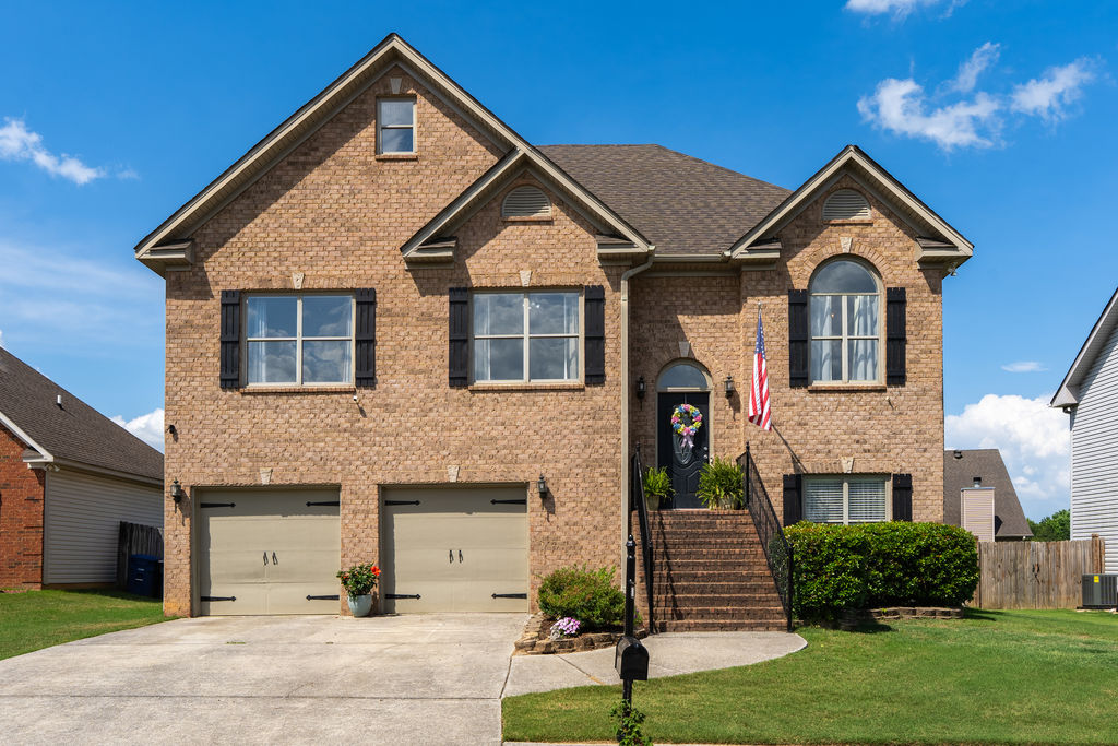 Brick exterior and two-car garage at 3029 Stonecreek Trace, a 4 bedroom home in Helena, AL