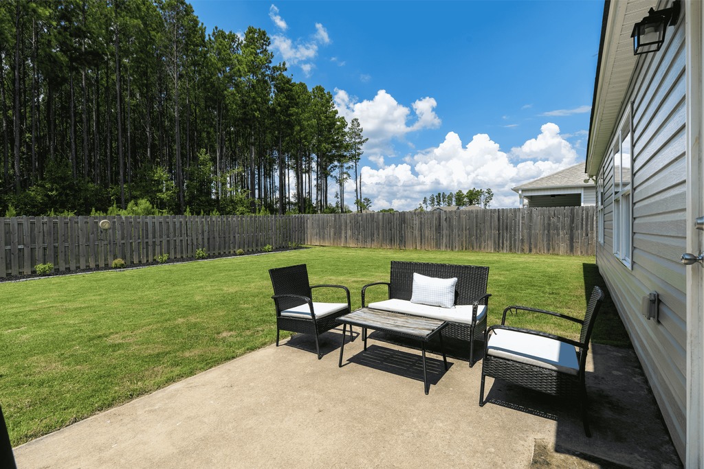 Concrete patio and large fenced backyard at 741 Fish Camp Road in Chelsea, AL