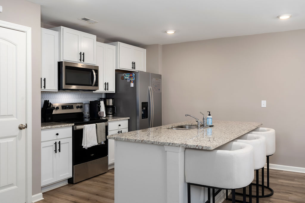 Kitchen with granite island and stainless appliances in Chelsea, AL