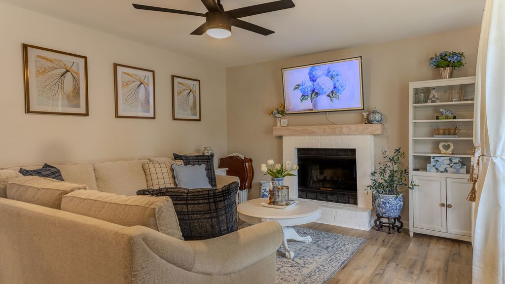 Living room with fireplace and new LVP flooring in an Alabaster, AL home