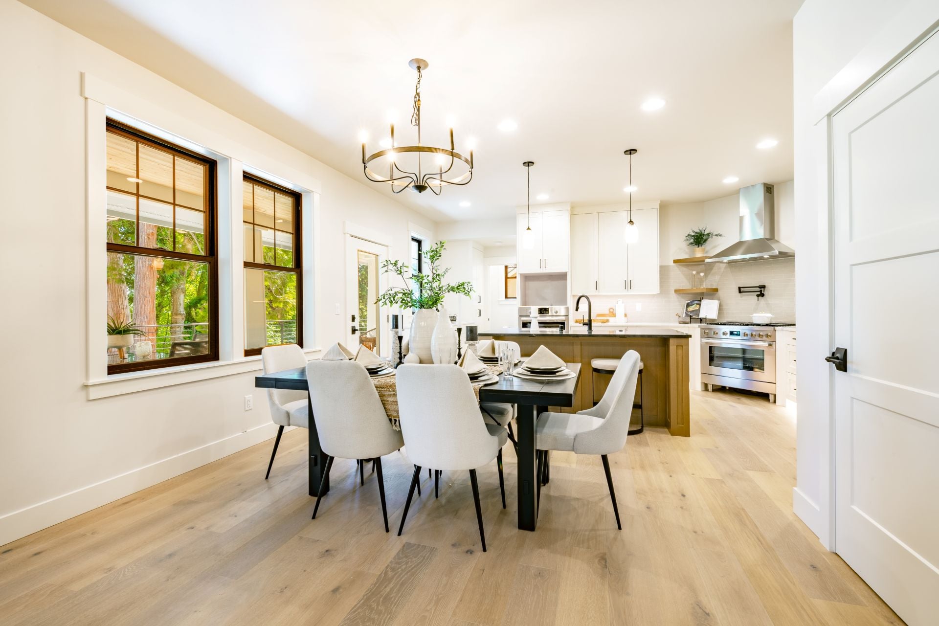 interior kitchen and dining room with high end appliances table with setting white counter and cabinets (2)