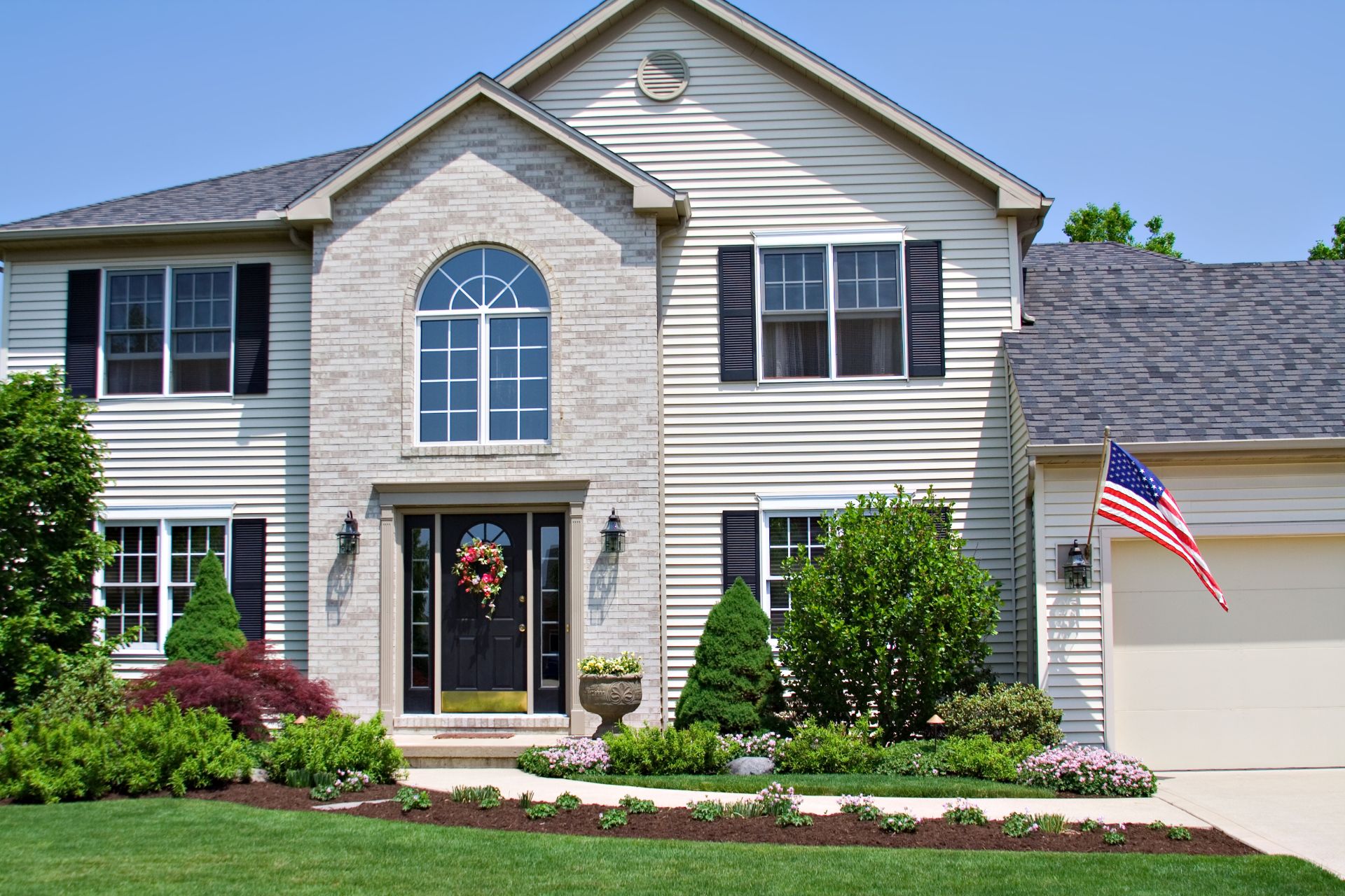 A beautiful neat suburban home in Northwest flying the American Flag.