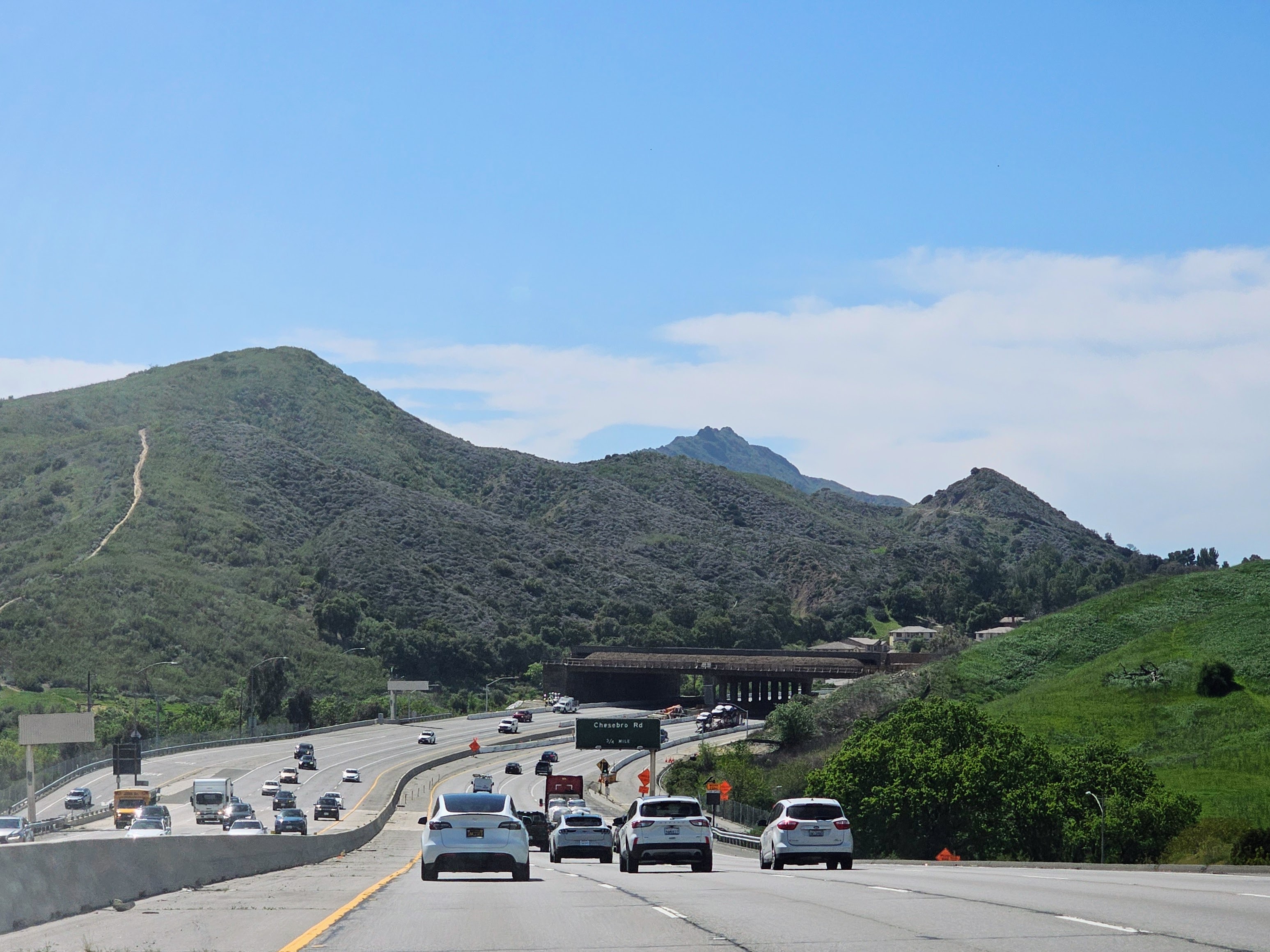 The Wallis Annenberg Wildlife Crossing spanning US 101, with the Santa Monica Mountains beyond, April 2025