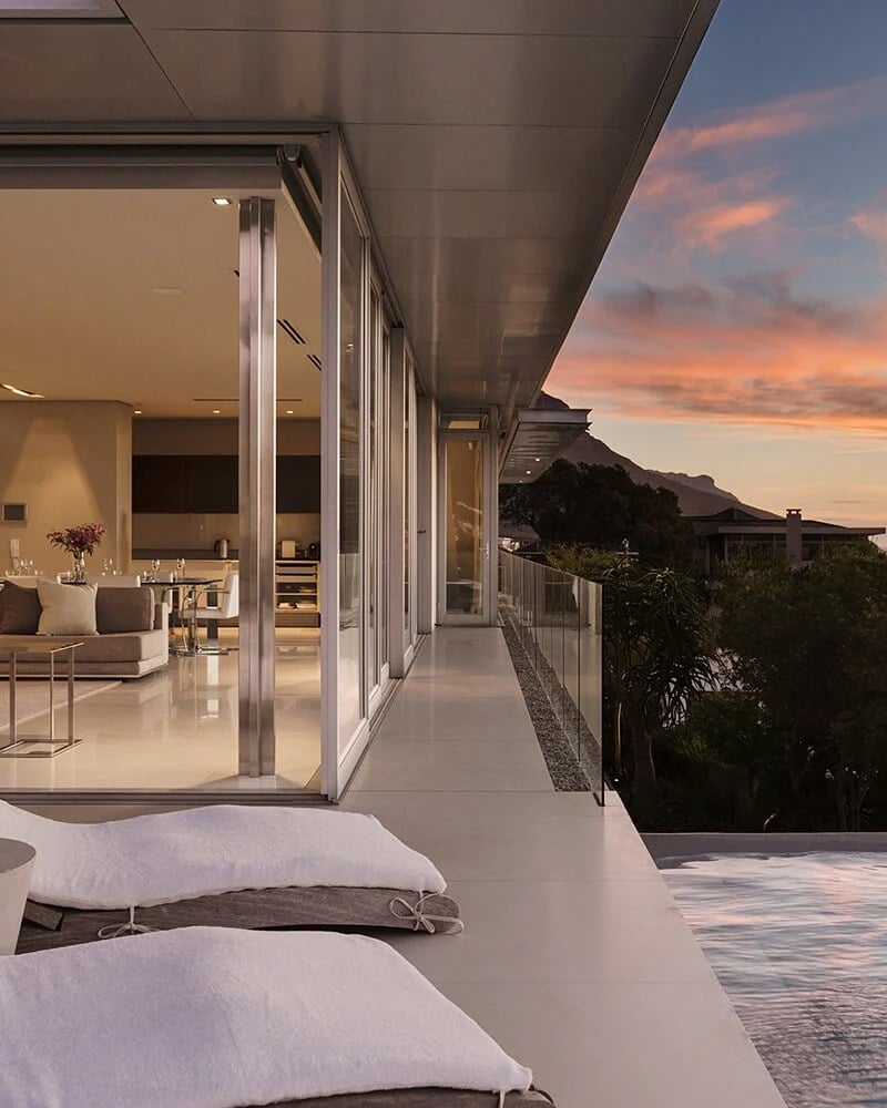 Buying: terrace of a modern hillside home at dusk