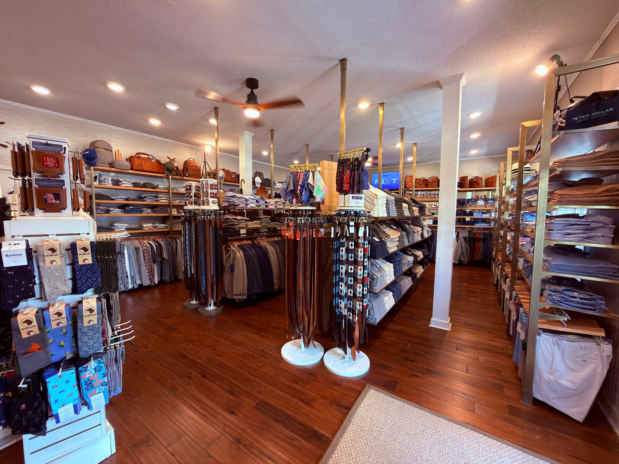 Newly remodeled showroom at Pawleys Island Men's Store at Oak Lea, with hardwood floors, belts, shirts and shoes