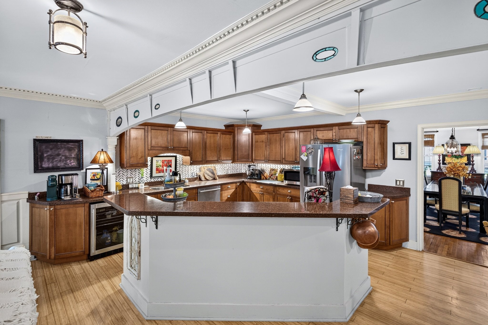Ship-hull beam with stained-glass openings between the living room and kitchen at 500 Orange St, Georgetown SC